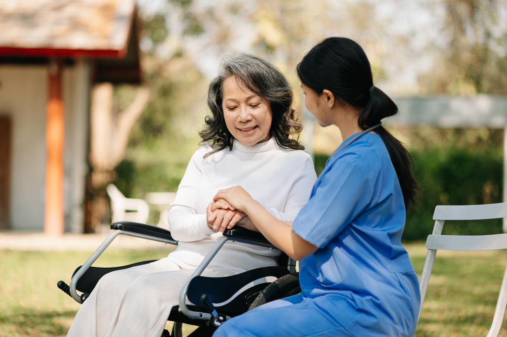 Asian female hands touching old female hand Helping hands take care of the elderly concept in hospital